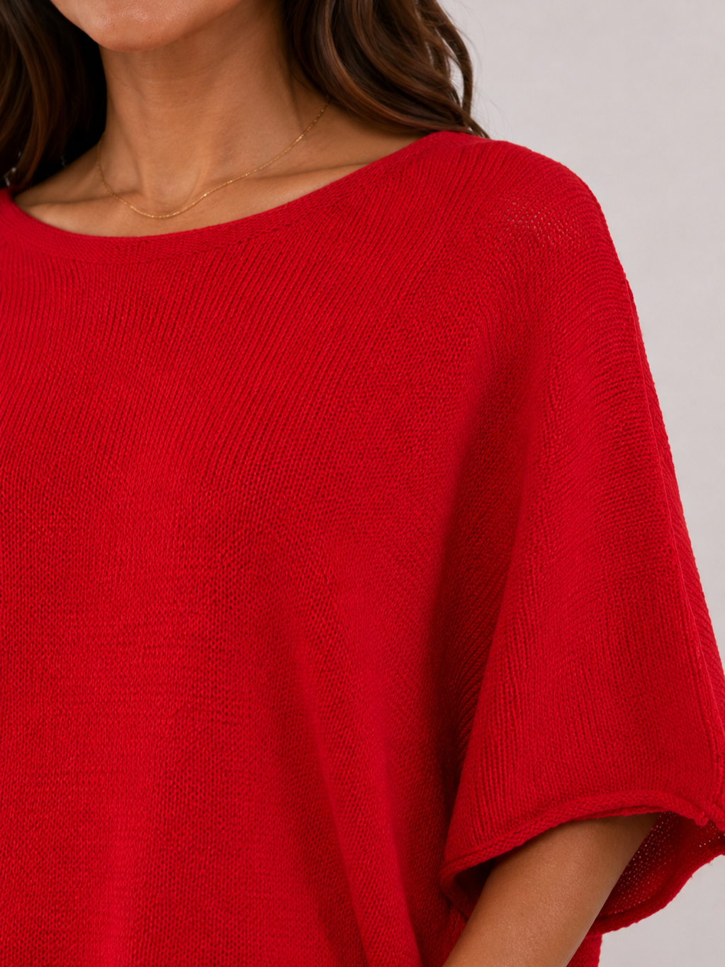 Red knit fabric close-up of Pop Me Over Oversized 3/4 Sleeve Knit Top by Plum Loco showing texture and sleeve detail