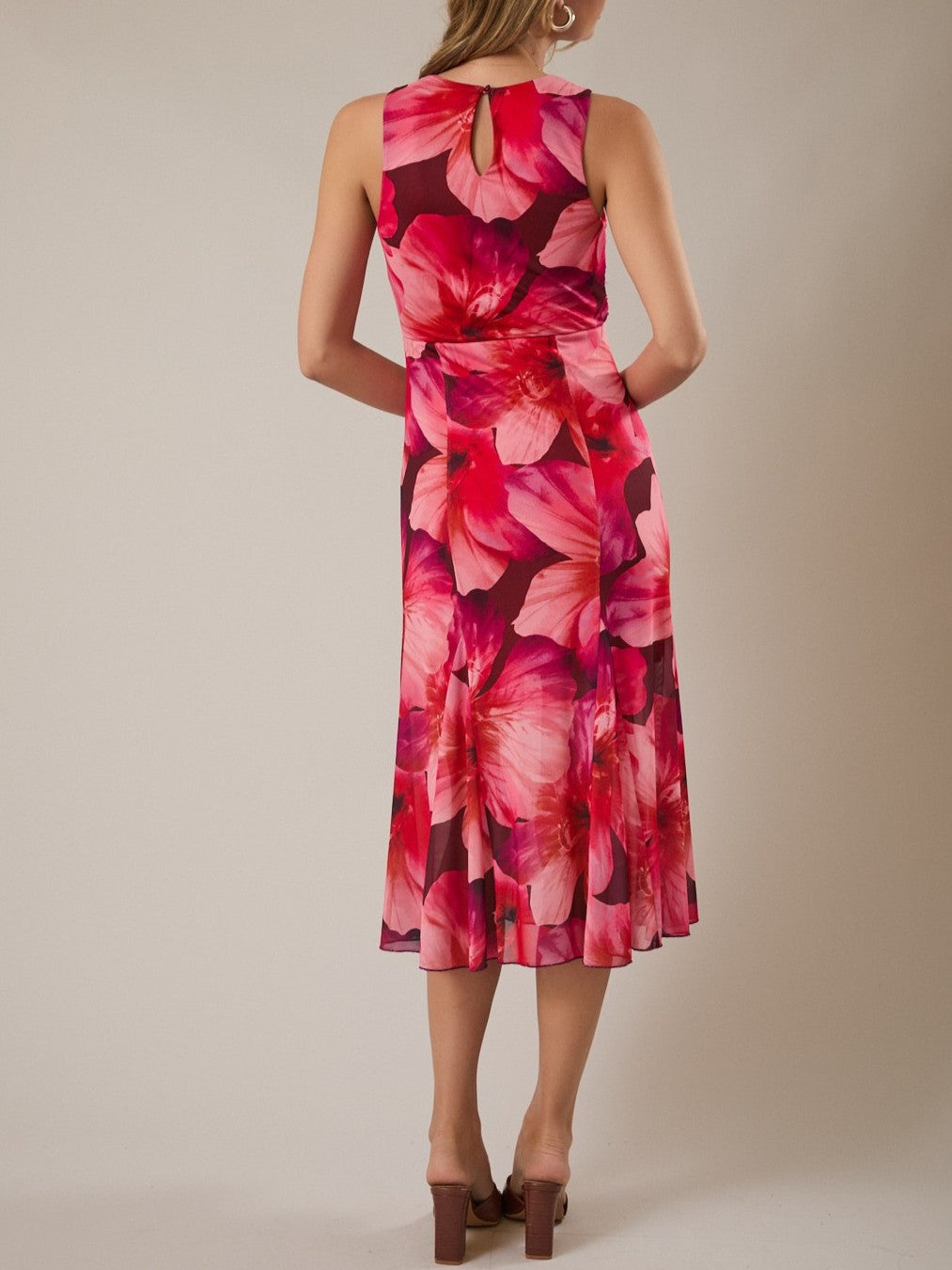 Sleeveless midi dress with large pink and red floral print and keyhole back detail.