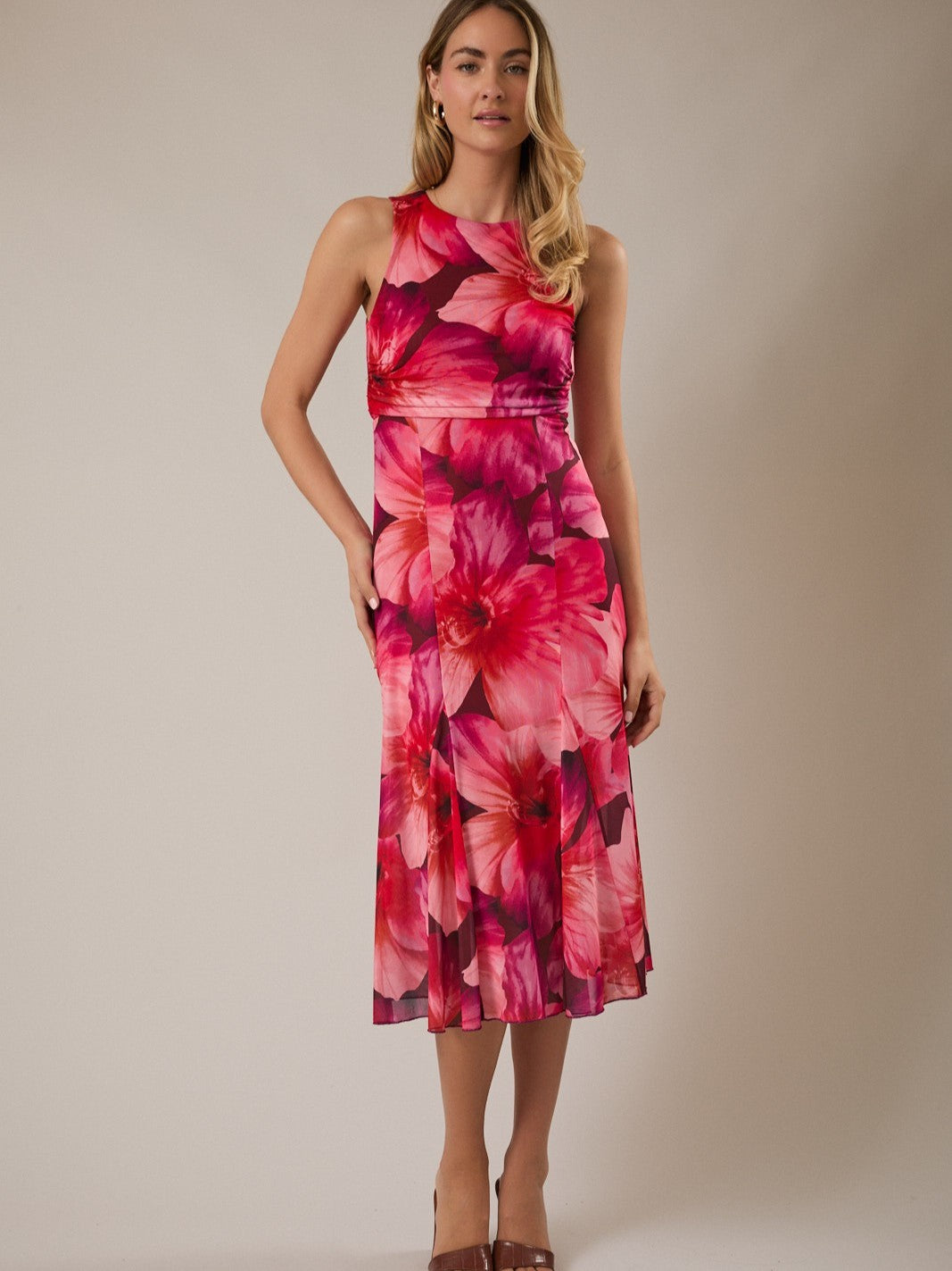 Sleeveless Floral Flow Ruched Midi Dress by Gilli in vibrant pink and red floral print with a fitted ruched waist detail.