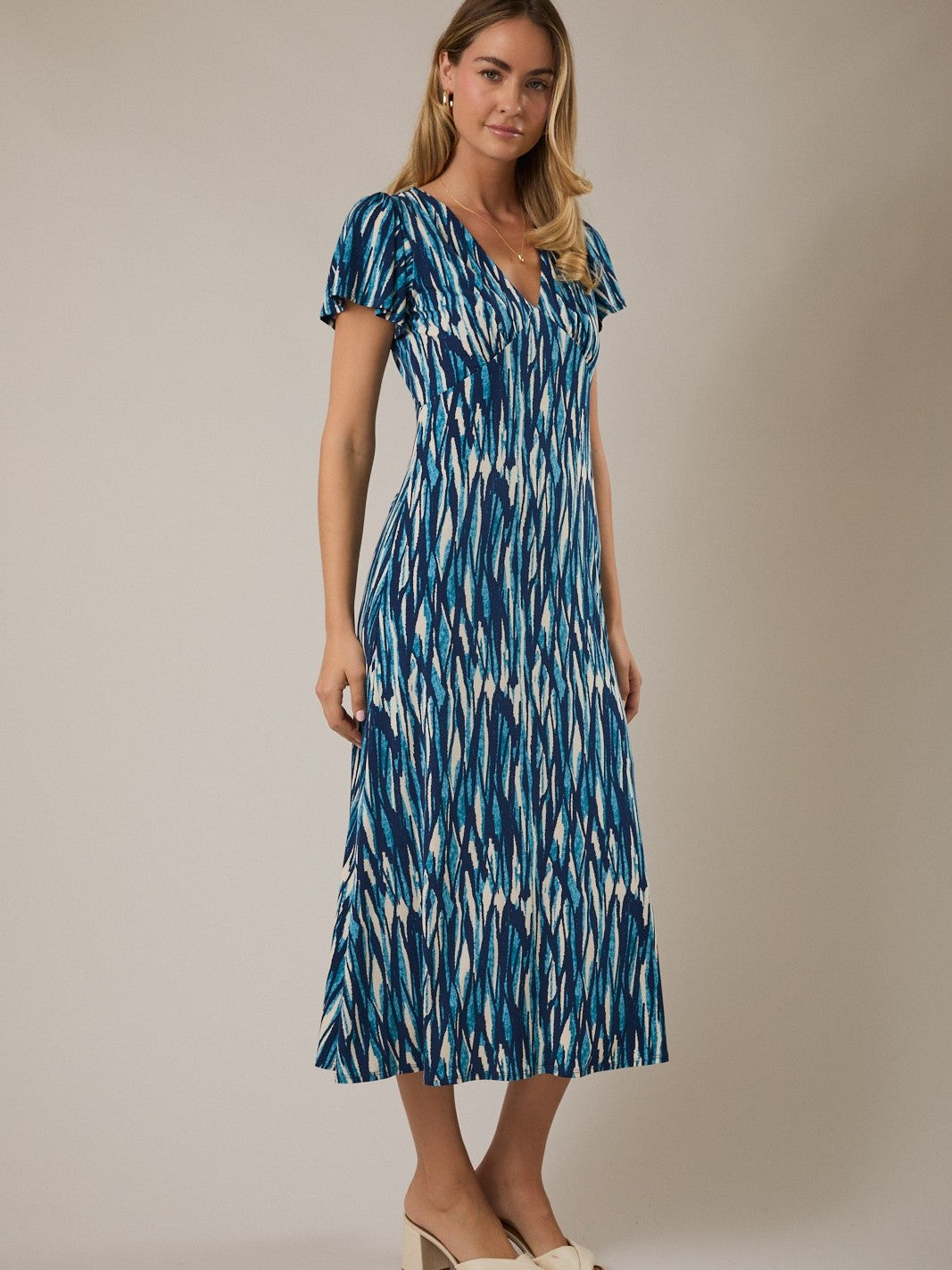 Ocean Print Back Tie V-Neck Midi Dress by Gilli in blue and white patterned fabric with short sleeves and a flowing skirt.