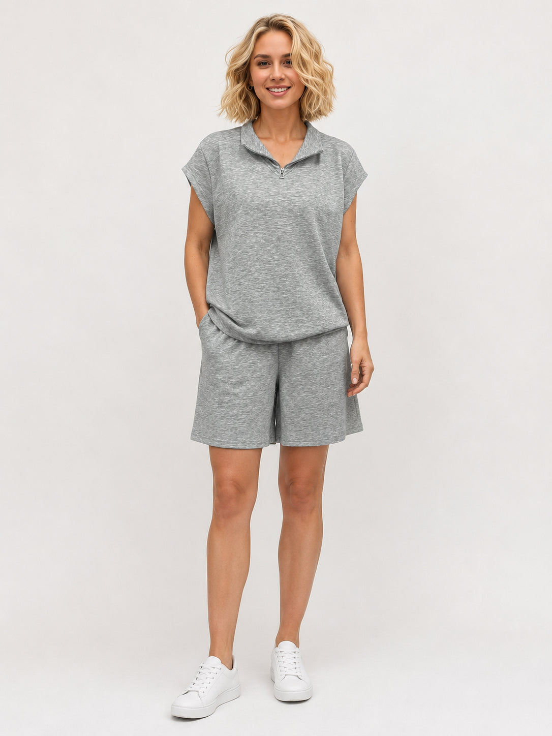 Creation Lulu 1/4 Zip Short Sleeve Top by Creations in grey knit fabric paired with matching shorts and white sneakers.