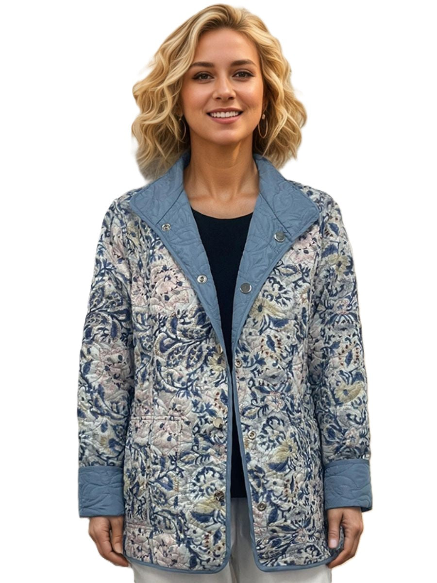 Lily Floral Reversible Quilted Jacket by Creations in floral denim pattern, featuring snap buttons and cozy quilted fabric.