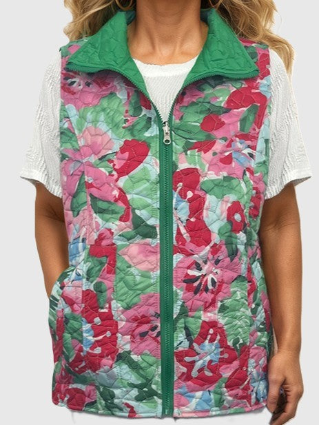 Quilted vest with green collar and floral pattern in shades of red, pink, and green over white knit top.