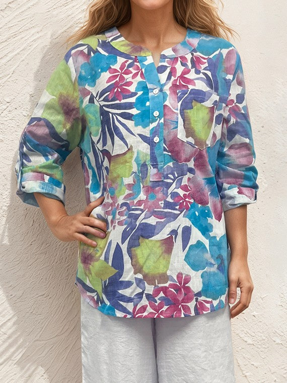 Creation Johanna Printed Roll Sleeve Top by Creations featuring vibrant floral pattern with blue, green, and purple hues.