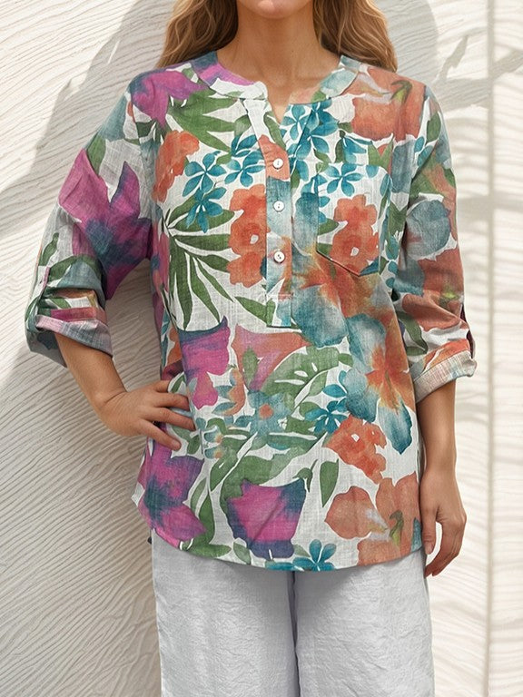 Creation Johanna Printed Roll Sleeve Top by Creations with multicolor floral print and button front detail, styled with white pants.