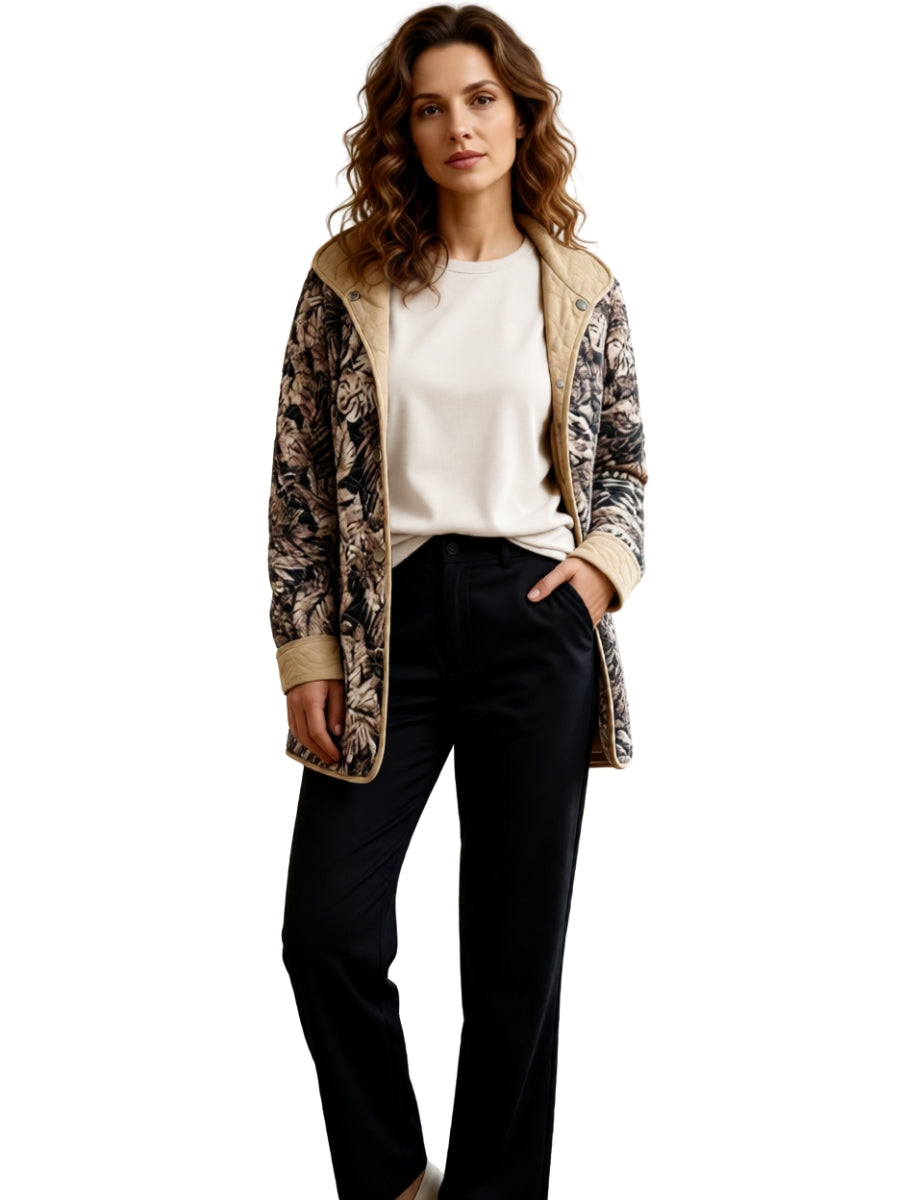 Long floral patterned taupe and beige quilted jacket paired with a light beige top and black trousers