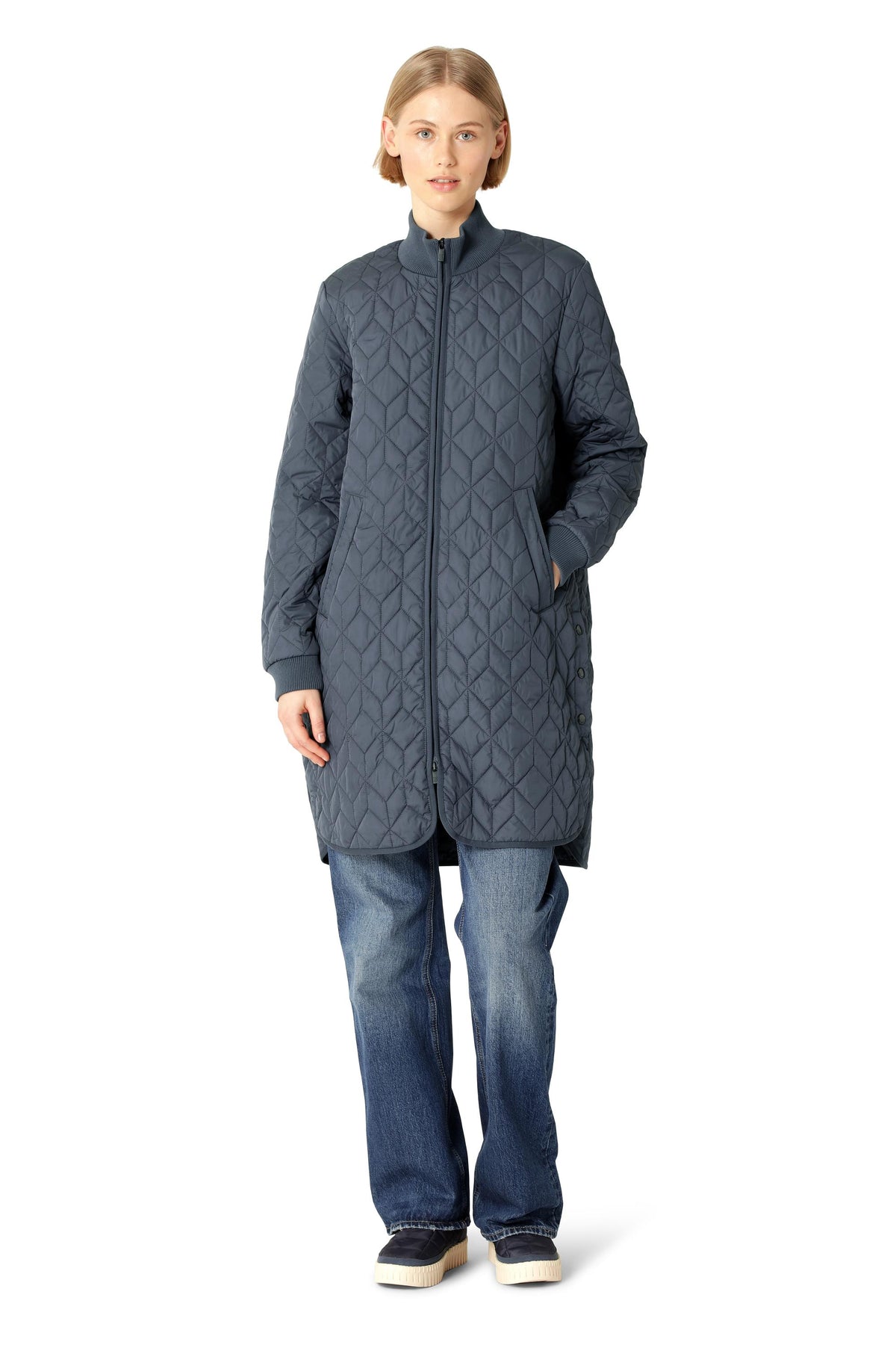 Ilse Jacobsen Quilted Coat in navy blue with geometric stitching, long silhouette, and front pockets, styled with jeans.