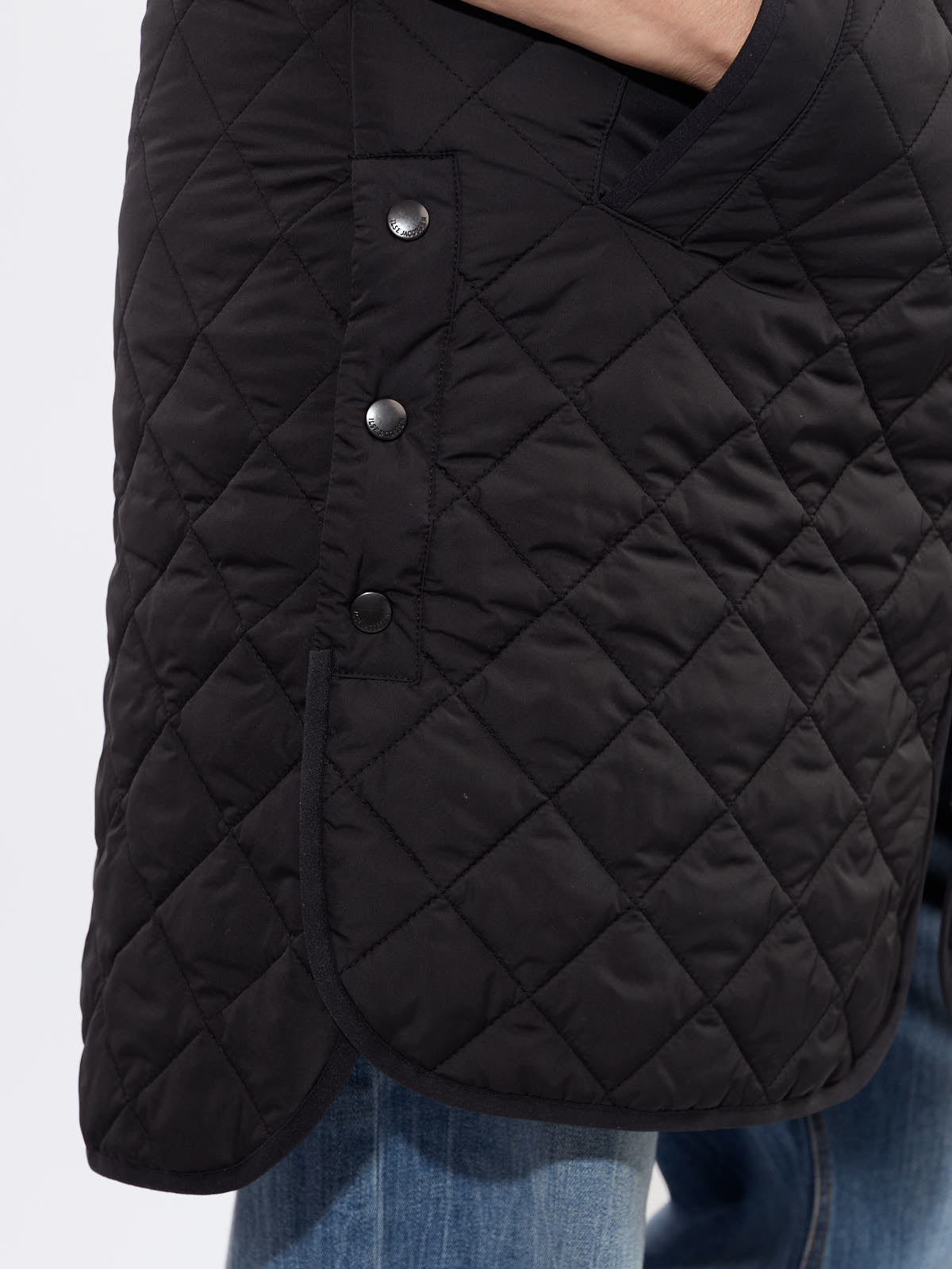 Ilse Jacobsen Quilted Vest in black with diamond stitching, side snap buttons, and curved hem detail