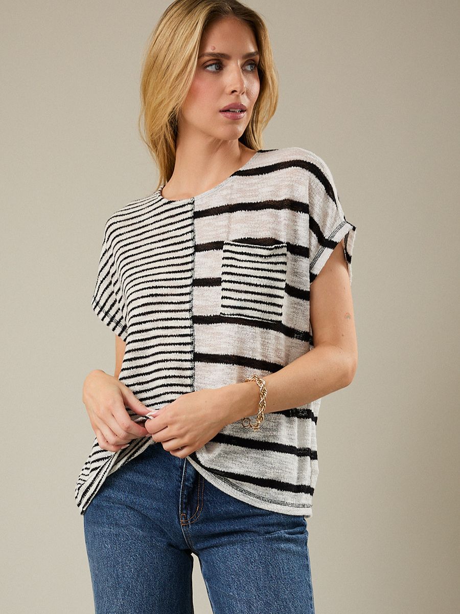 Woman wearing a black and white striped shirt with a neutral background