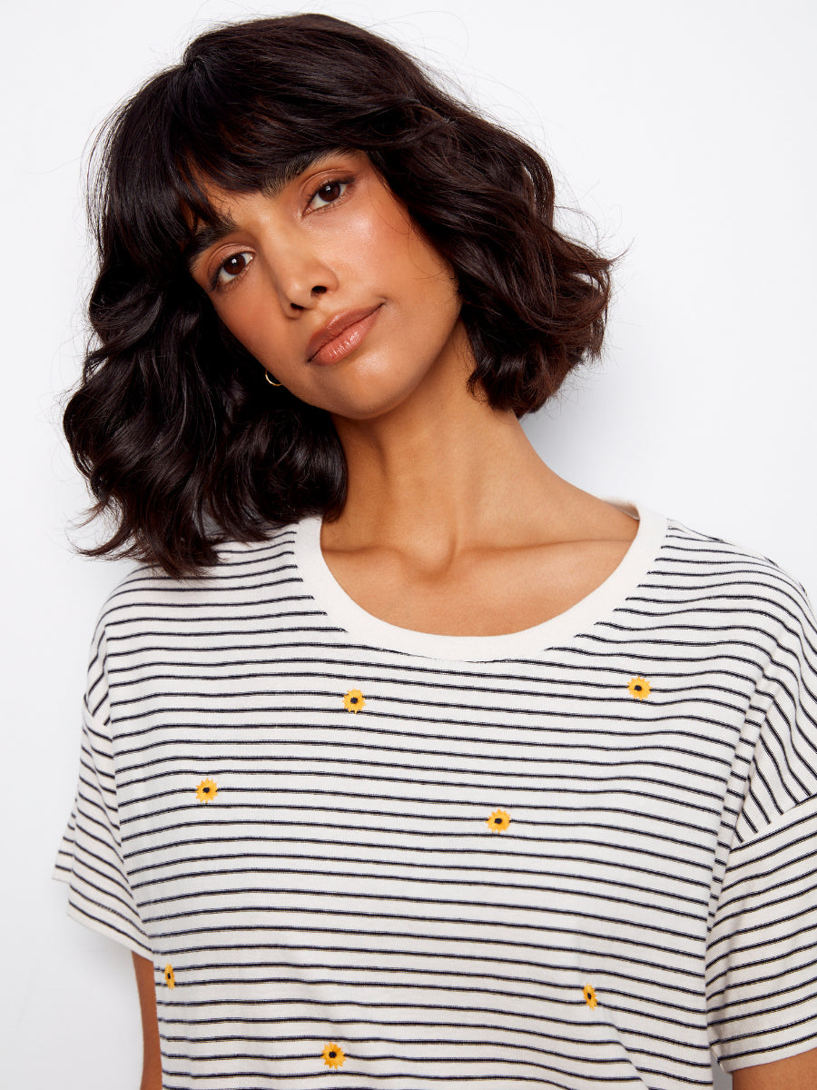 Close-up of striped Charlie B Daisy Graphic Cotton T-Shirt with small yellow daisies, styled by Charlie B.