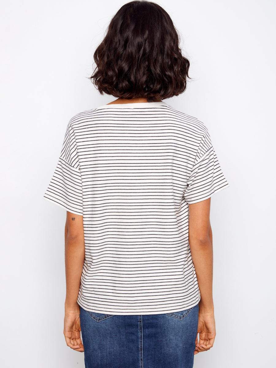 Back view of Charlie B Daisy Graphic Cotton T-Shirt in white with thin black stripes by Charlie B top