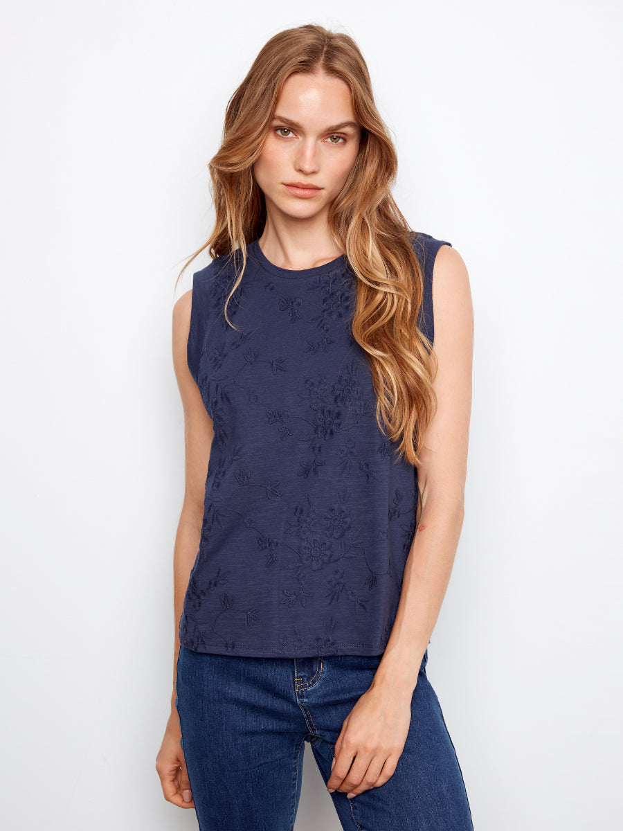 Charlie B Embroidered Flower Cotton Top in navy with subtle floral embroidery, styled with blue denim jeans.
