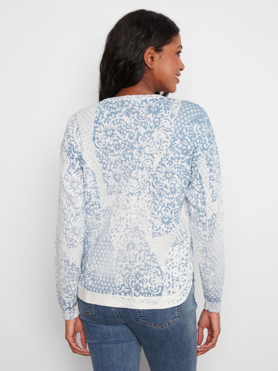 Back view of a long-sleeve sweater with blue and white intricate floral and geometric patterns