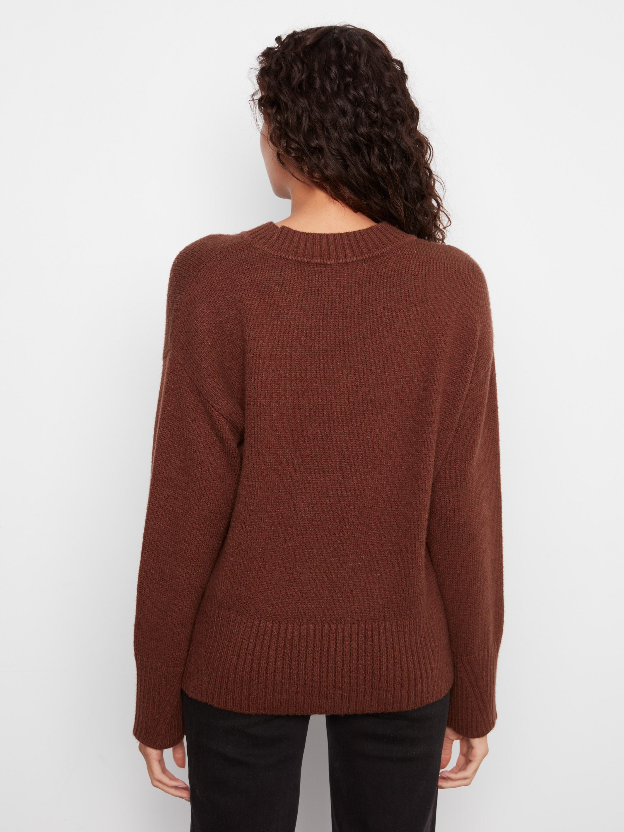 Back view of a brown knit sweater with ribbed hem and cuffs against a white background.