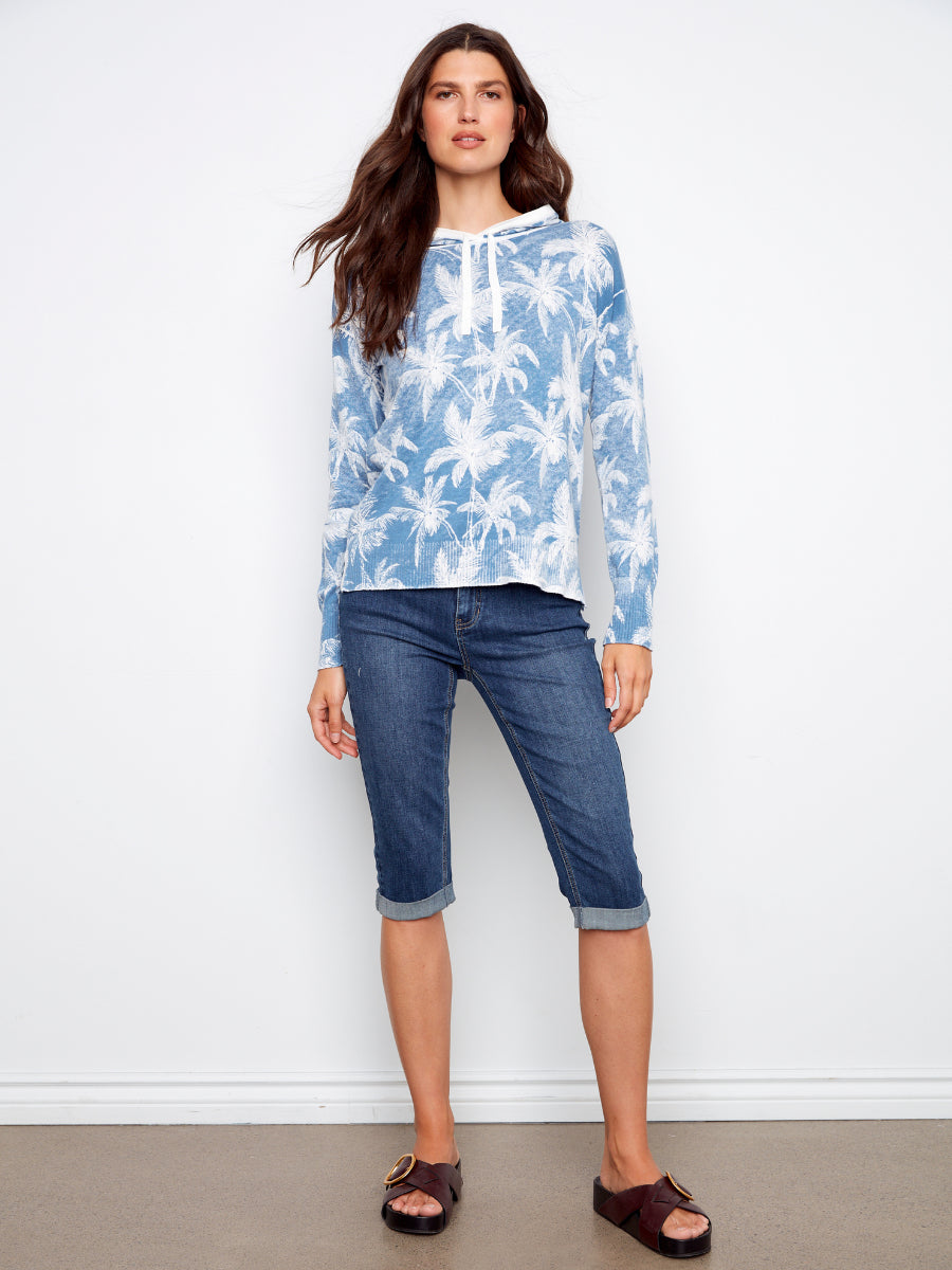 Charlie B Palms Tropical Hooded Pullover Top in blue palm print paired with denim capris and sandals by Charlie B