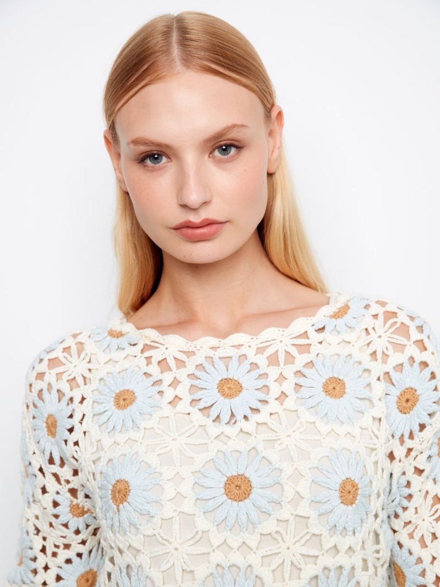 Close-up of a floral crochet top with light blue and tan flowers, the Charlie B Floral Crochet Crew Neck Top from Charlie B.