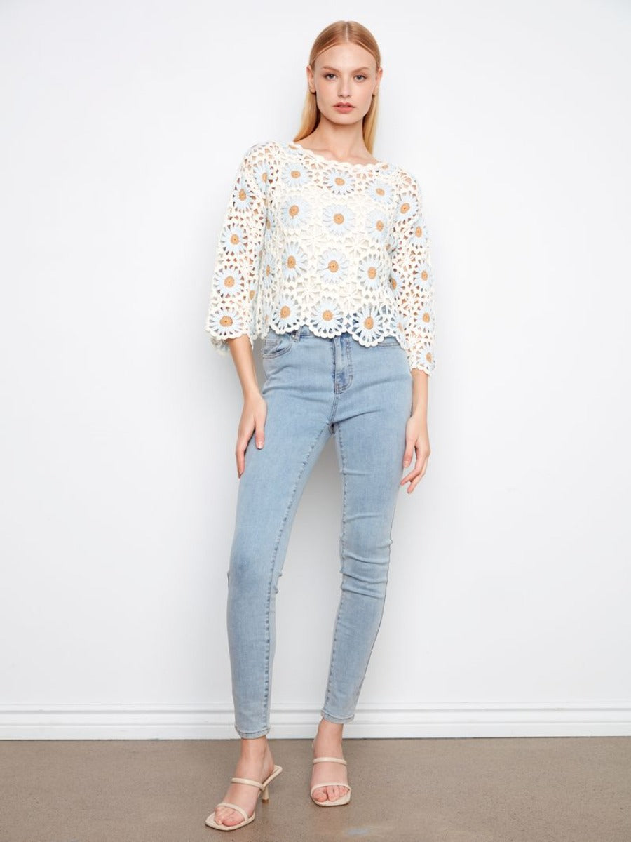 Slim fit light wash jeans paired with a Charlie B Floral Crochet Crew Neck Top in white by Charlie B.