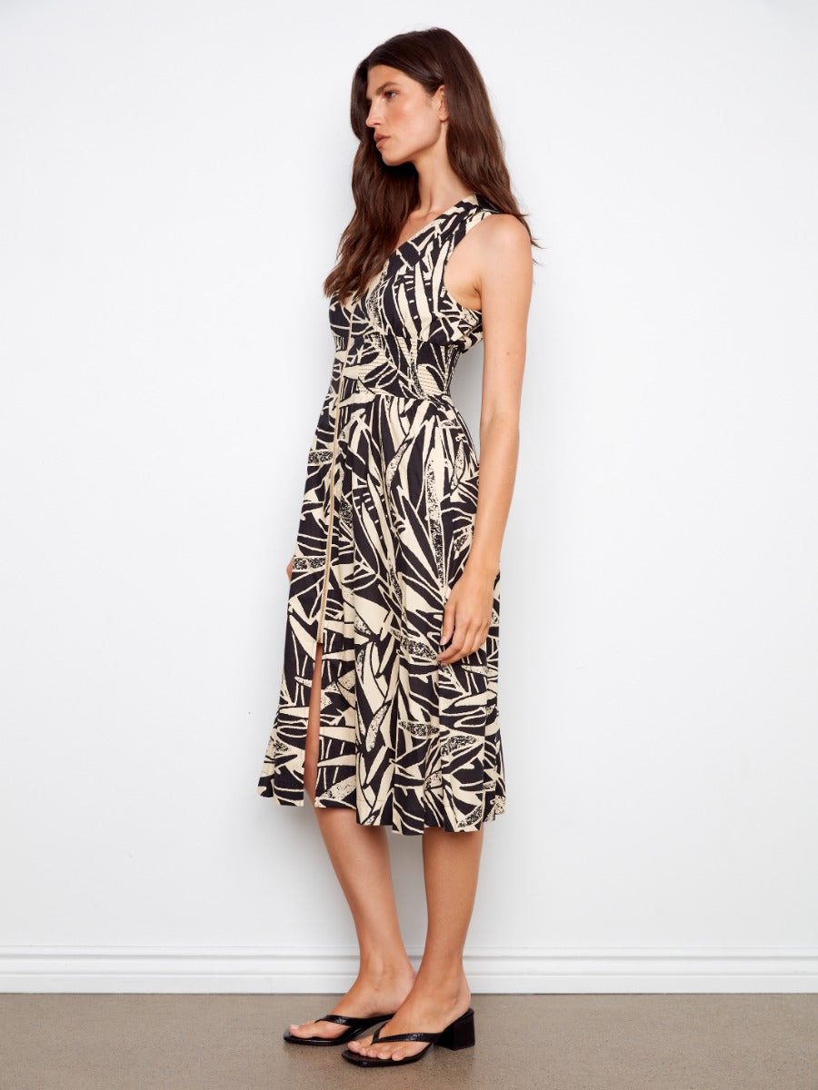 Side view of a model in a black and beige leaf print Charlie B Simon Printed Cotton Zip Front Midi Dress by Charlie B