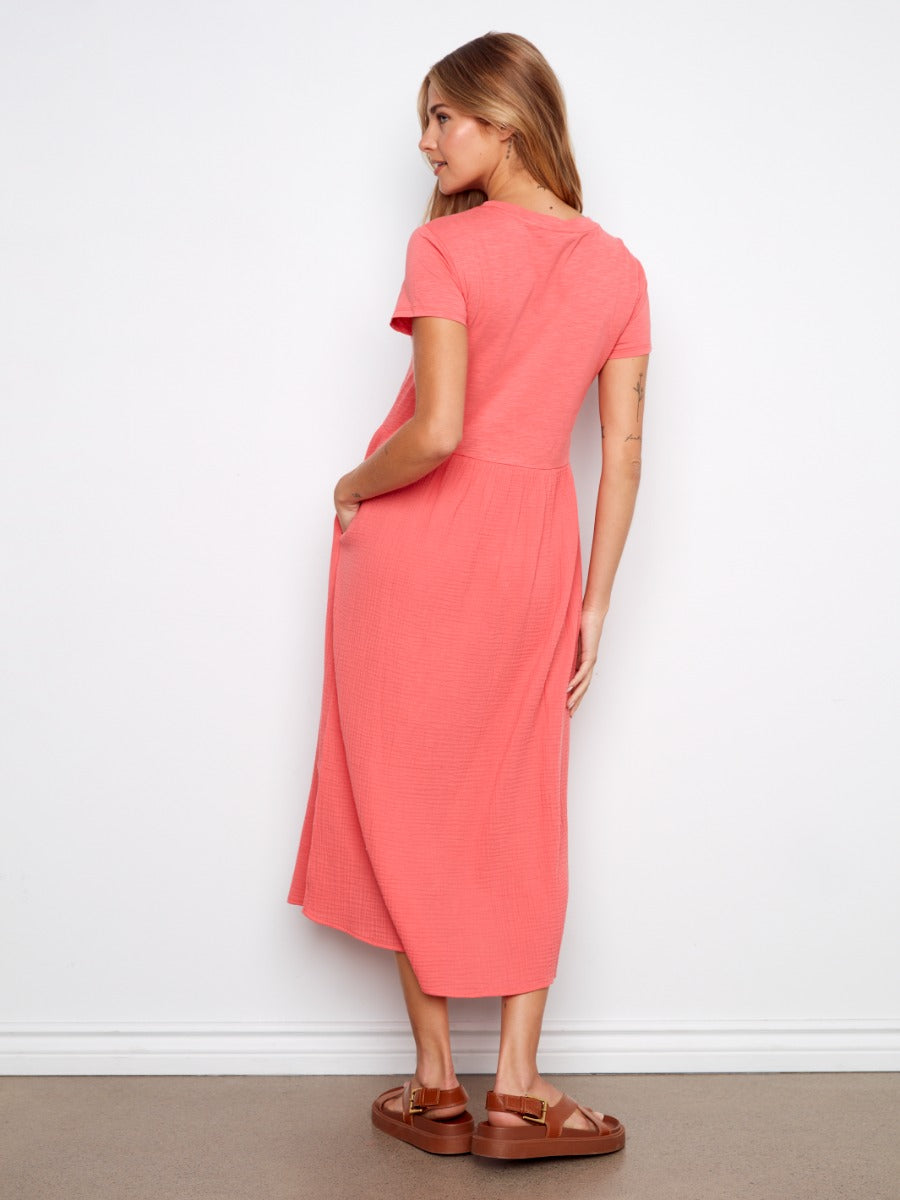 Back view of coral Charlie B Bubble Textured Short Sleeve Knit Dress in relaxed fit with pockets and brown sandals