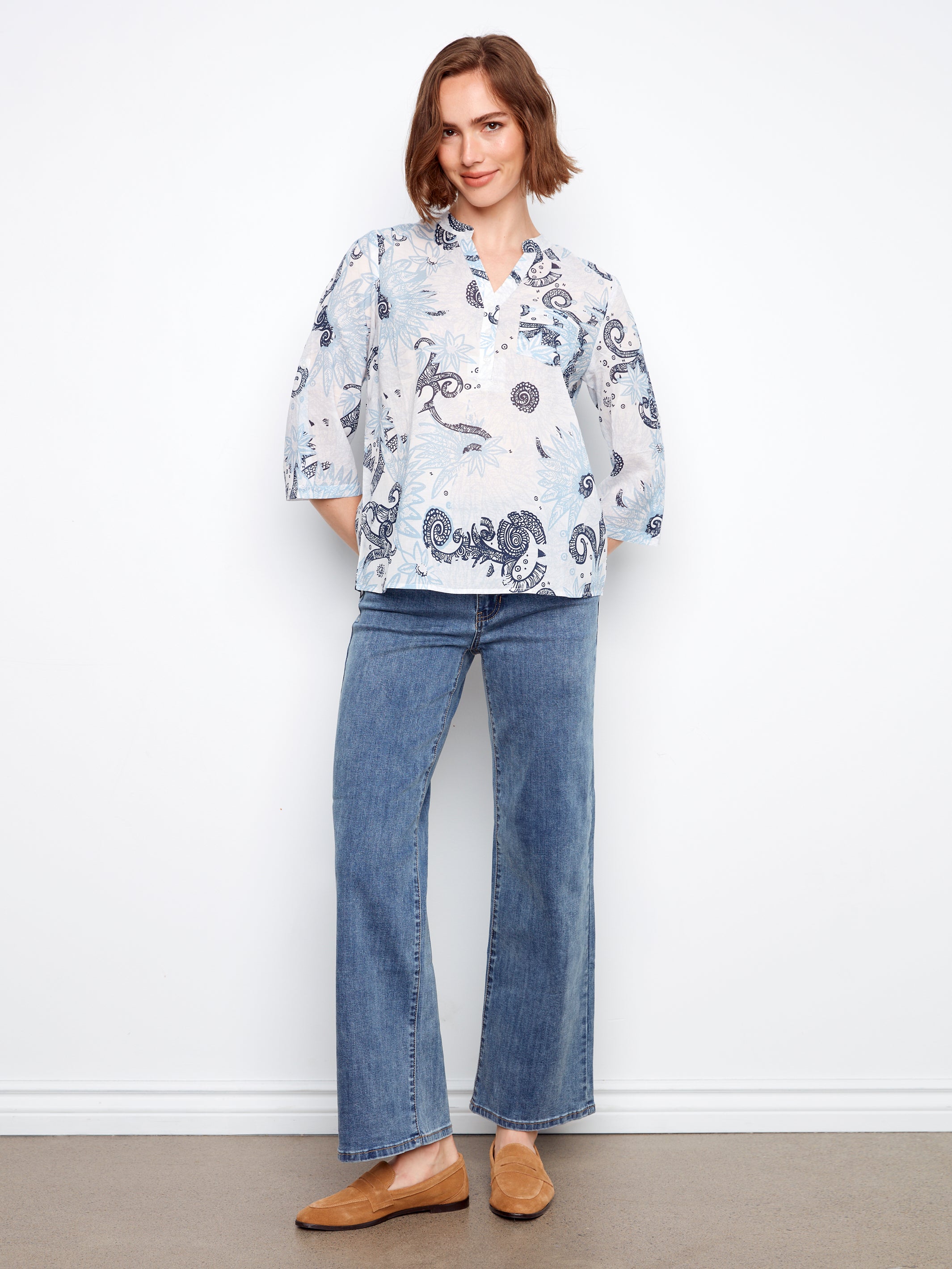 Charlie B Johanna Textured Gauze Roll Sleeve Top in light blue paisley pattern, styled with casual jeans and loafers.