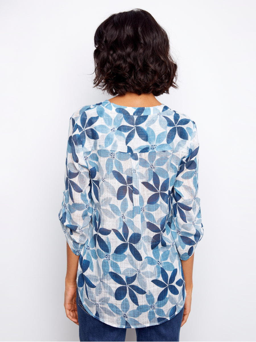 Back view of Charlie B Johanna Floral Textured Gauze Roll Sleeve Top with blue floral pattern and textured fabric