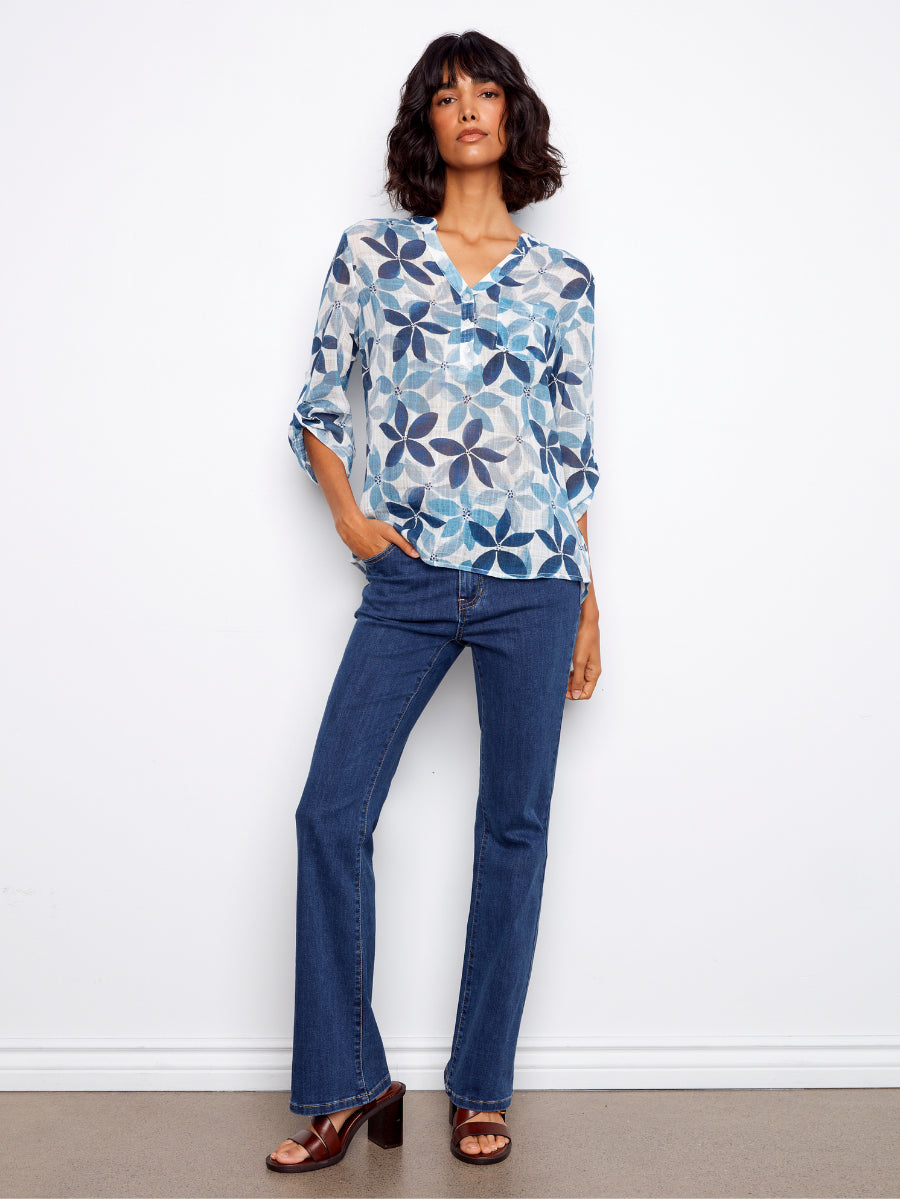 Charlie B Johanna Floral Textured Gauze Roll Sleeve Top in blue floral pattern paired with dark denim jeans by Charlie B