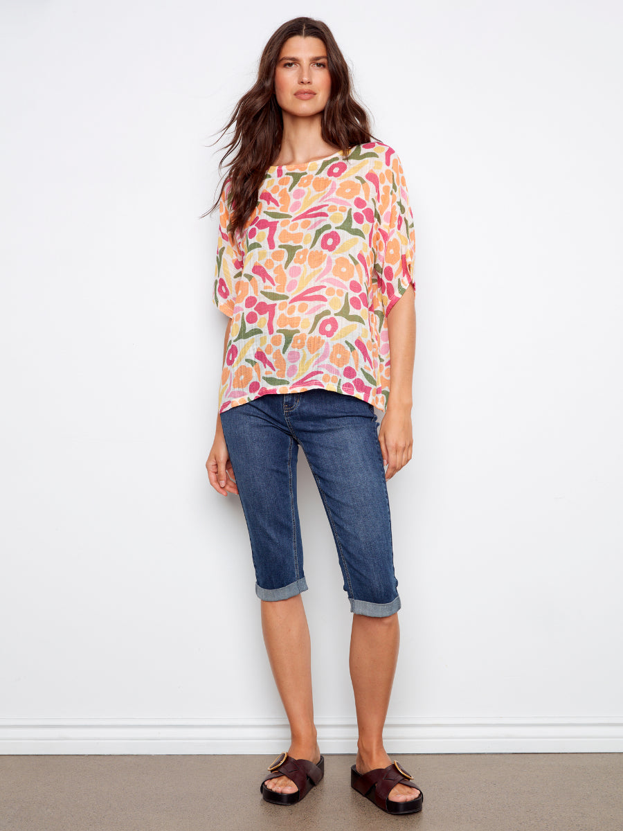 Charlie B Solstice Cotton Gauze Short Sleeve Top in colorful floral print paired with cuffed denim shorts and sandals