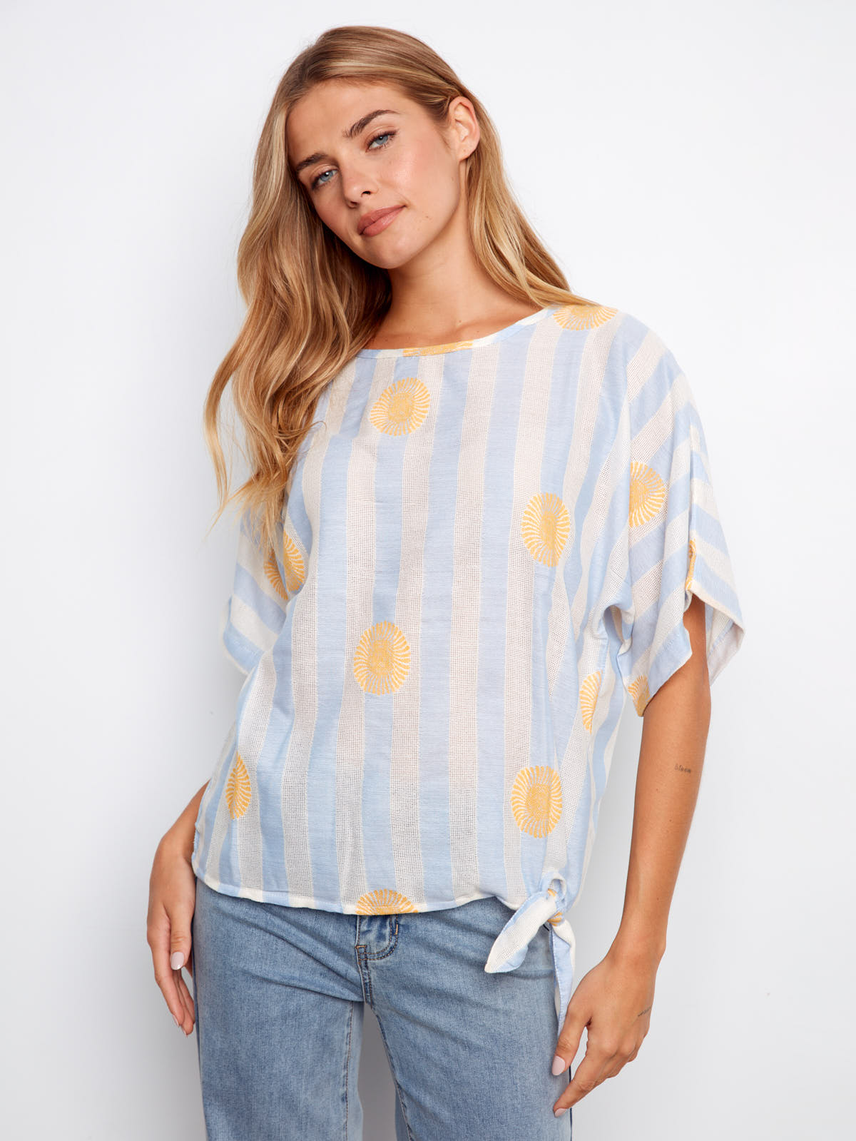 Charlie B Sunrise Striped Tie Short Sleeve Top in light blue with yellow sunburst stripes styled with denim jeans