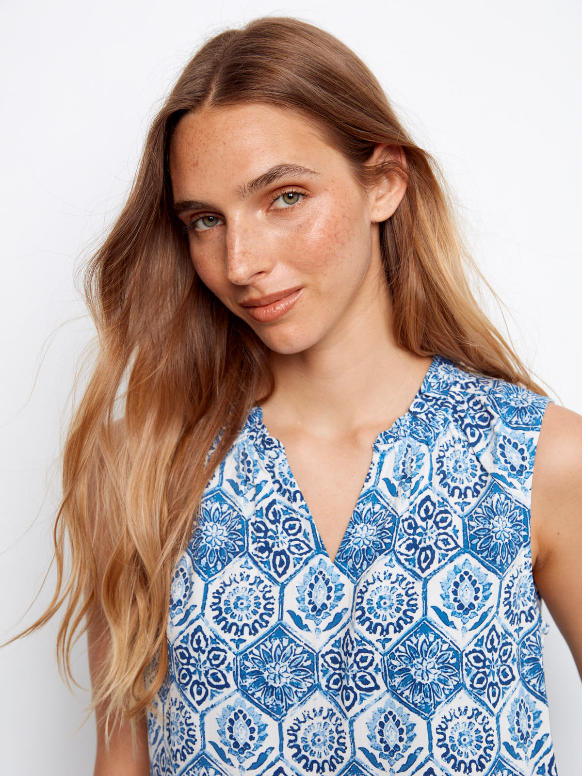 Model wearing a blue patterned Charlie B Layered or Not Ruffle Top sleeveless cotton blouse by Charlie B