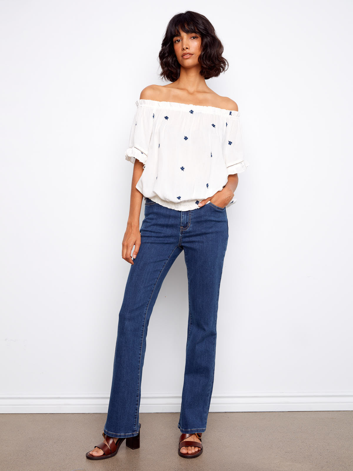 Charlie B Embroidered Clover Short Sleeve Top in white with navy clover embroidery, styled with casual denim jeans by Charlie B