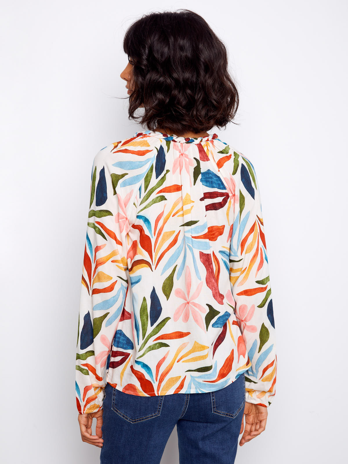 Charlie B Solstice V-Neck Raglan Top featuring colorful abstract leaf patterns and long sleeves in lightweight fabric