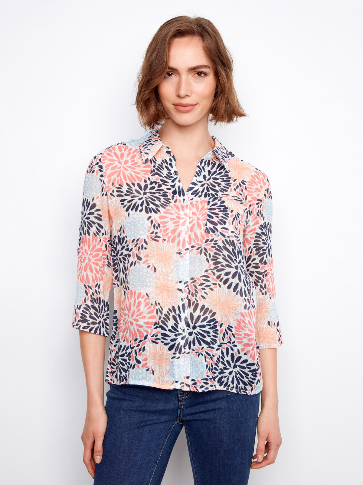 Charlie B Johanna Gauze Roll Sleeve Top with floral print in soft pastel colors paired with blue denim jeans by Charlie B