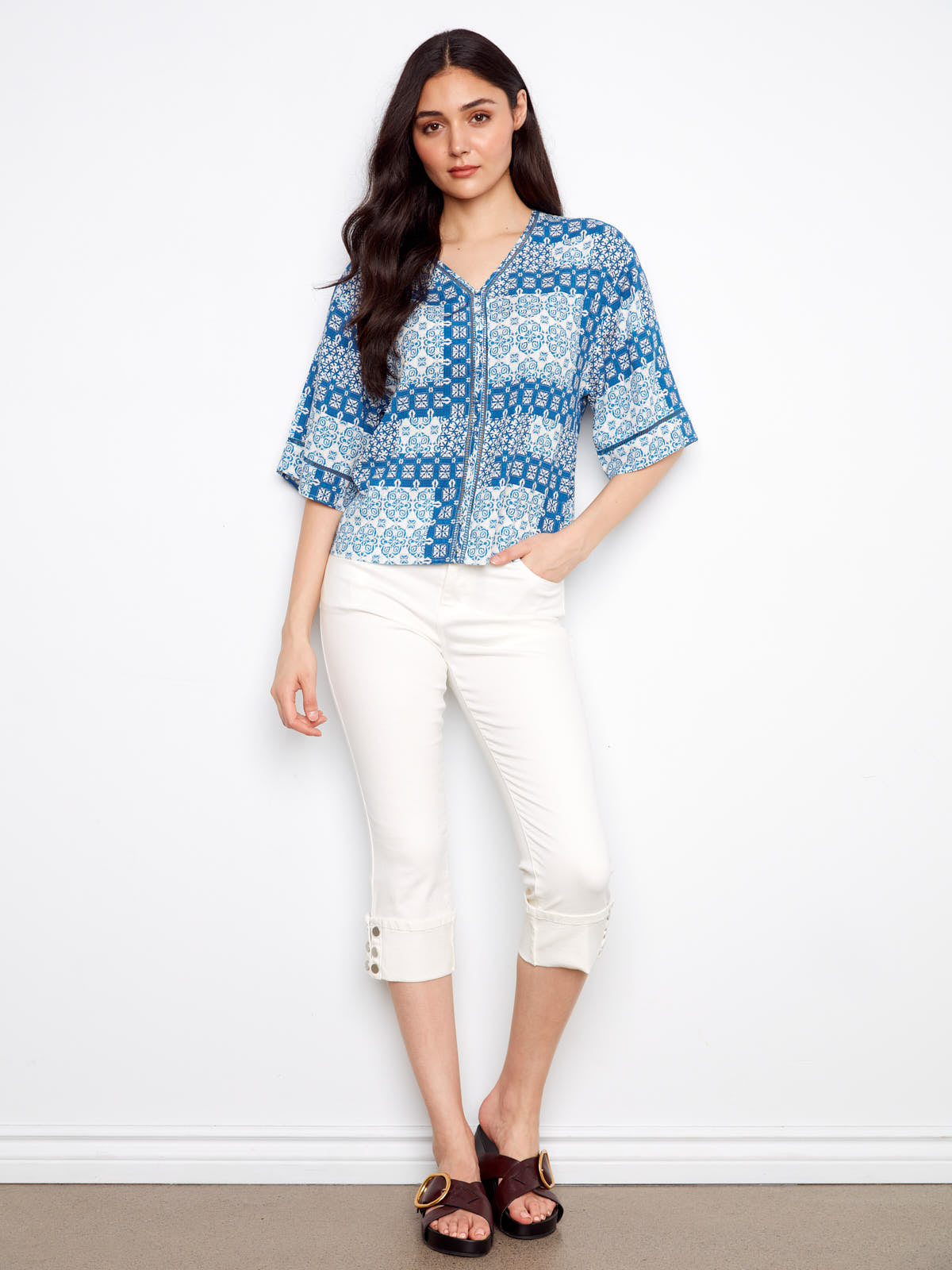Charlie B Patchwork ¾ Sleeve Top in blue patterned fabric paired with white cropped pants from Charlie B.