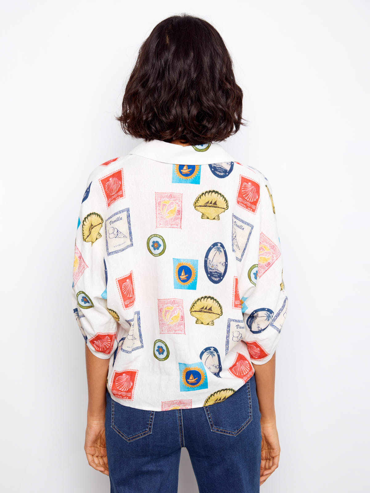 Back view of Charlie B Nautical Postcard Line Tie Top with colorful nautical postcard print and rolled sleeves by Charlie B