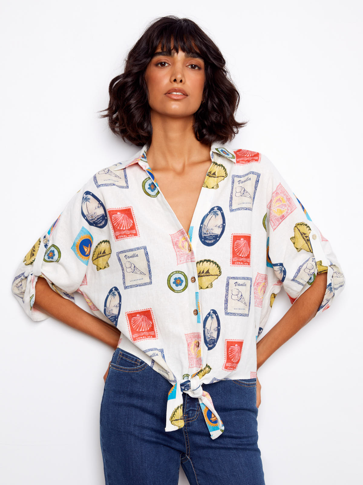 Charlie B Nautical Postcard Line Tie Top with colorful postcard print, worn with blue denim jeans by Charlie B