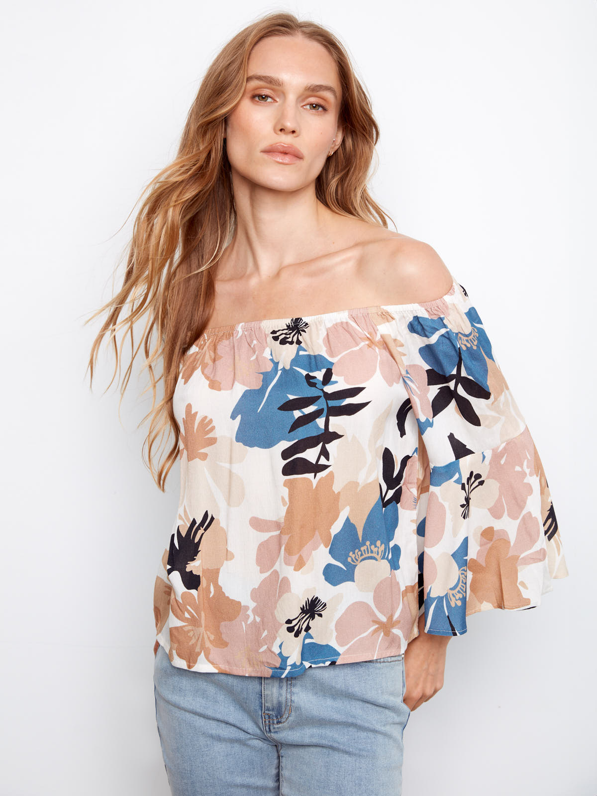 Charlie B Sassy Off the Shoulder Bell Sleeve Top with multicolor floral print, styled with light-wash denim jeans