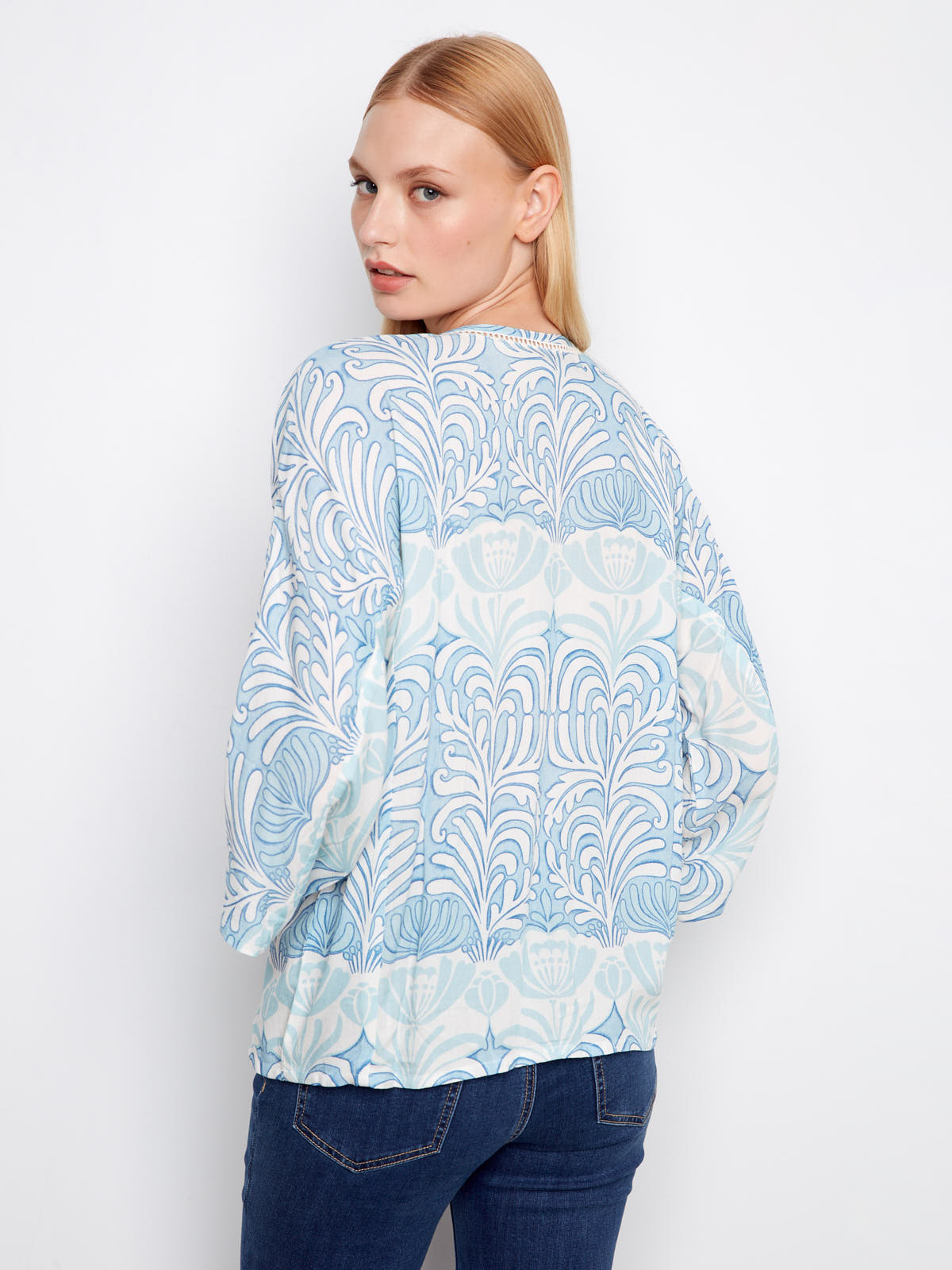 Model showing the back of the Charlie B Ibiza ¾ Sleeve Blouse with blue and white floral pattern by Charlie B.