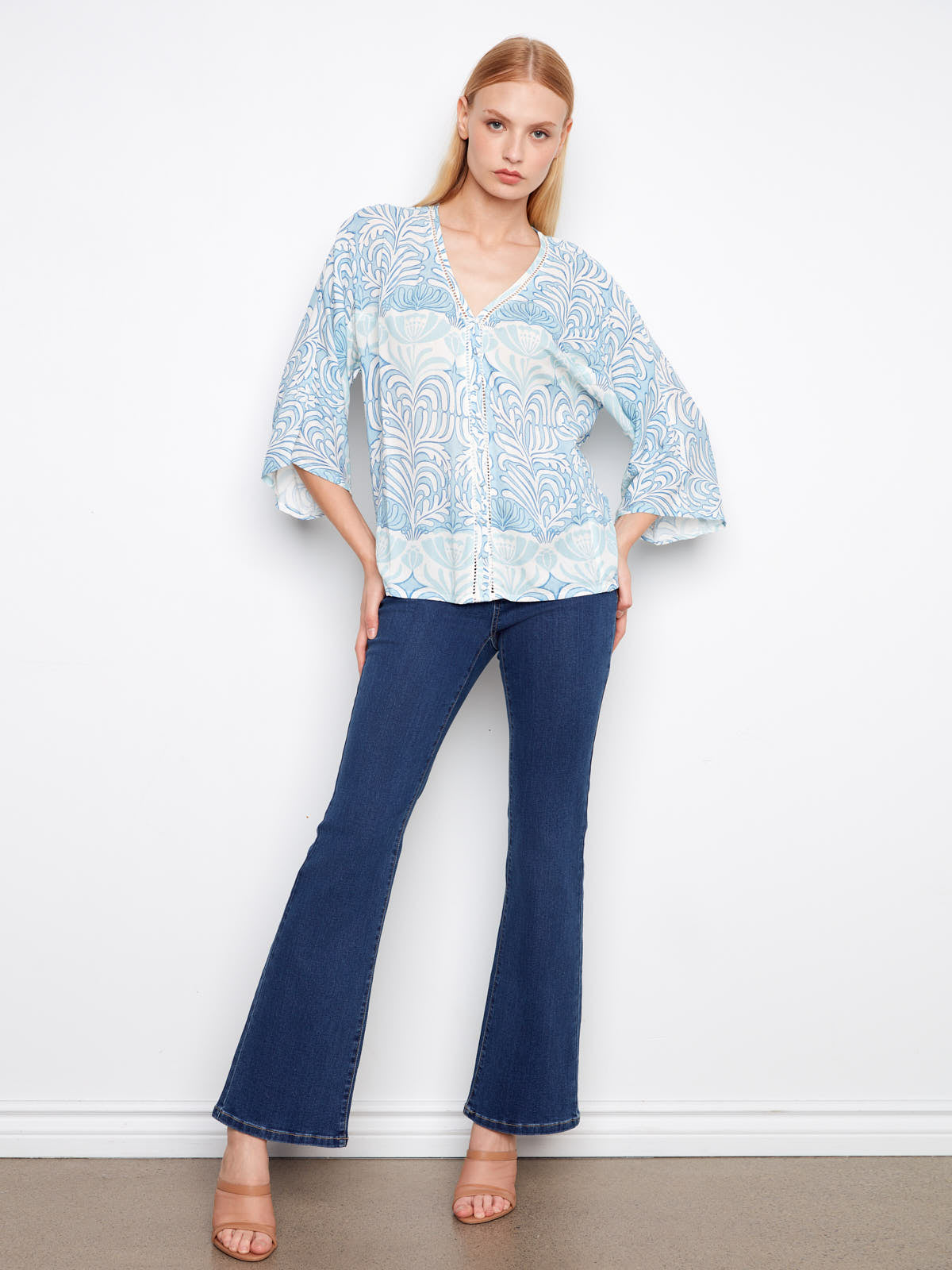 Light blue patterned Charlie B Ibiza ¾ Sleeve Blouse styled with dark blue flare jeans and neutral heels by Charlie B.