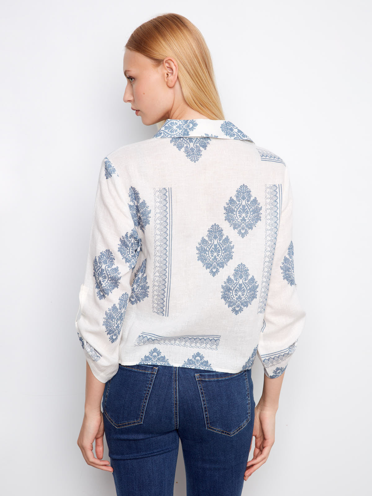 Back view of a blue and white patterned linen top paired with jeans featuring Charlie B Cool Guy Linen Button Front Tie Top