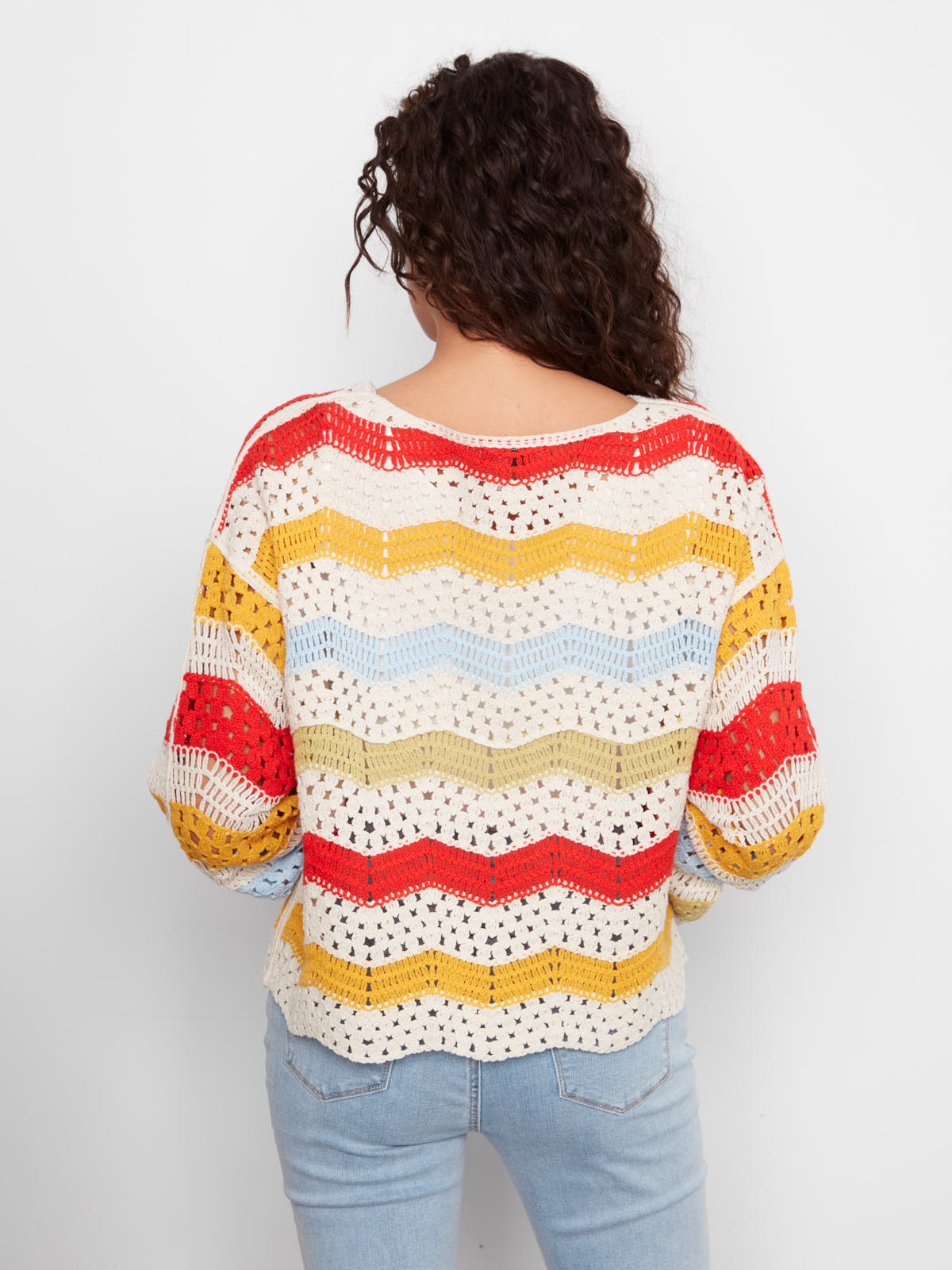 Back view of colorful crocheted sweater with red, yellow, blue, and green stripes by Charlie B, Charlie B Solstice Crochet Crew Top