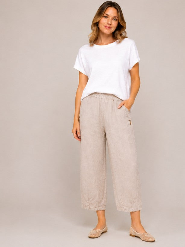 Linen Pleat Hem Cropped Capri Pants by Cherishh in beige with button details and elastic waist styling.
