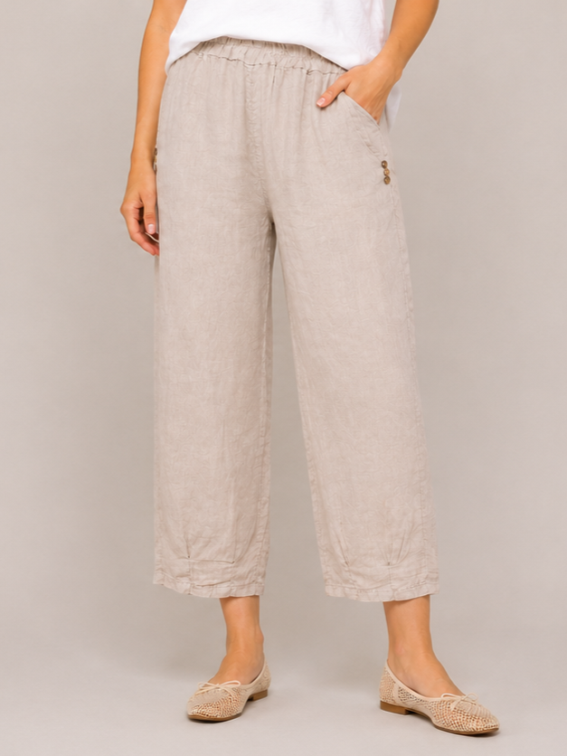 Linen Pleat Hem Cropped Capri Pants by Cherishh in beige with elastic waistband, side pockets, and button details.
