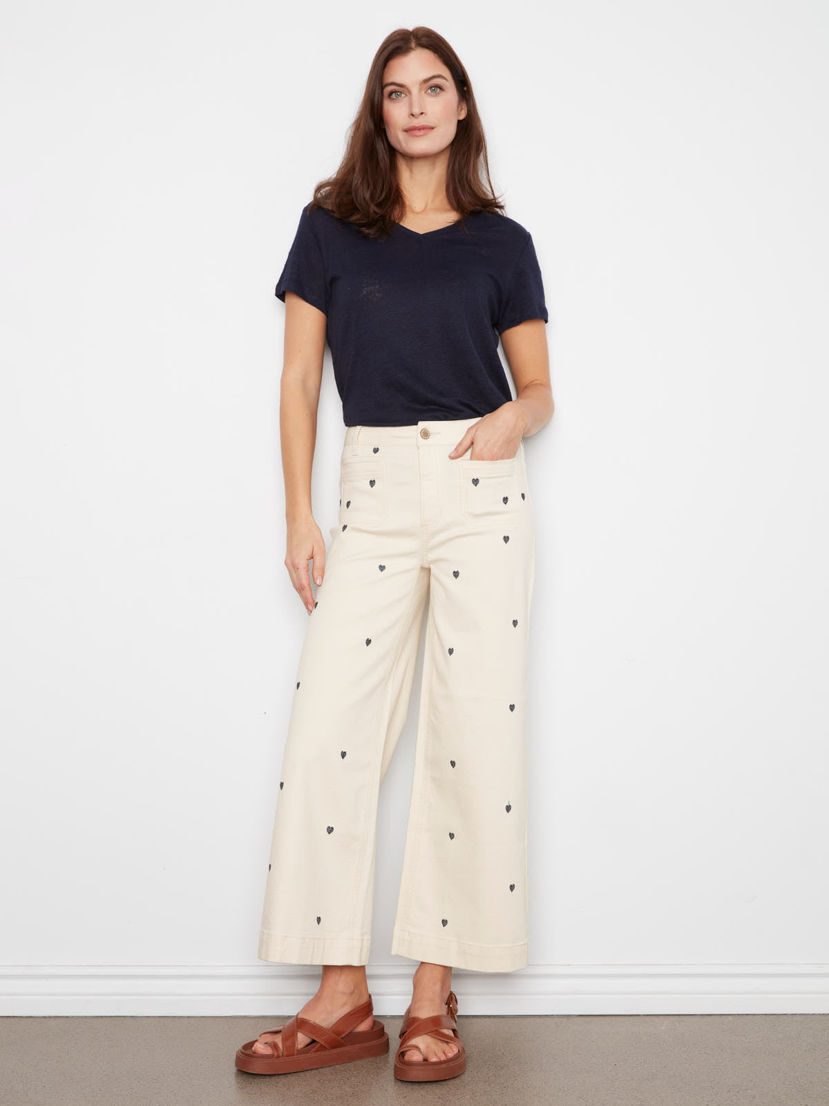 Slim fit navy top paired with cream Charlie B Hearts Double Trouble Denim Jean featuring heart prints by Charlie B