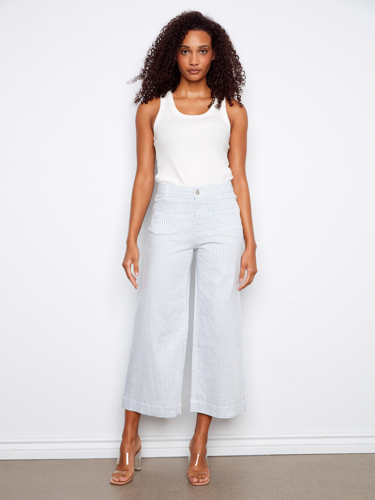Charlie B Double Trouble Lines Flare Jean in light blue stripes paired with clear heeled sandals by Charlie B