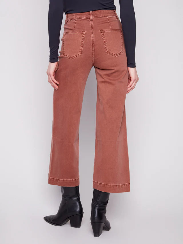 Back view of rust-colored Charlie B Double Trouble 27” Wide Leg Pants styled with black boots and top