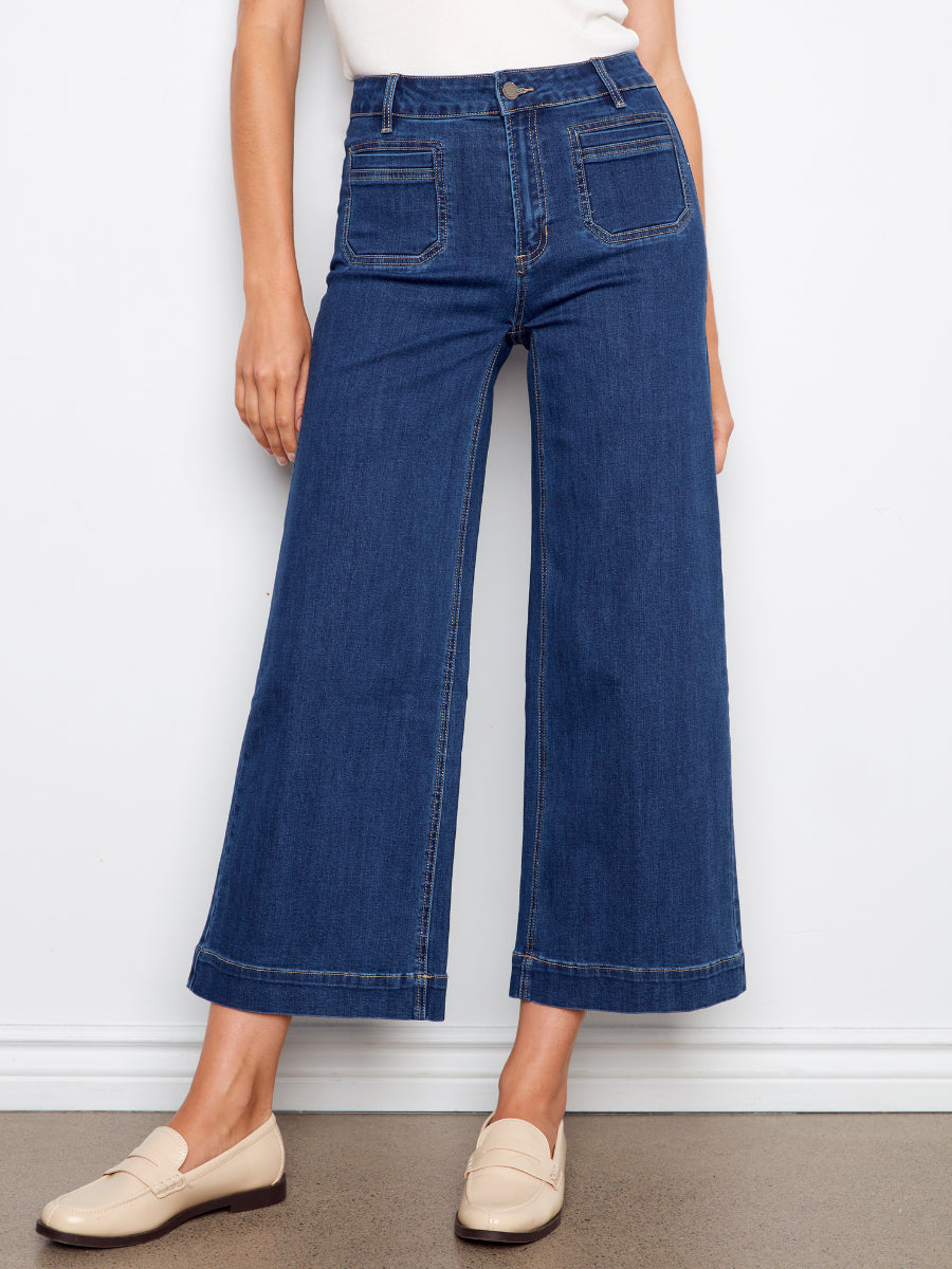 Charlie B Double Trouble High Rise Flared Denim Jeans in dark blue denim paired with beige loafers from Charlie B.