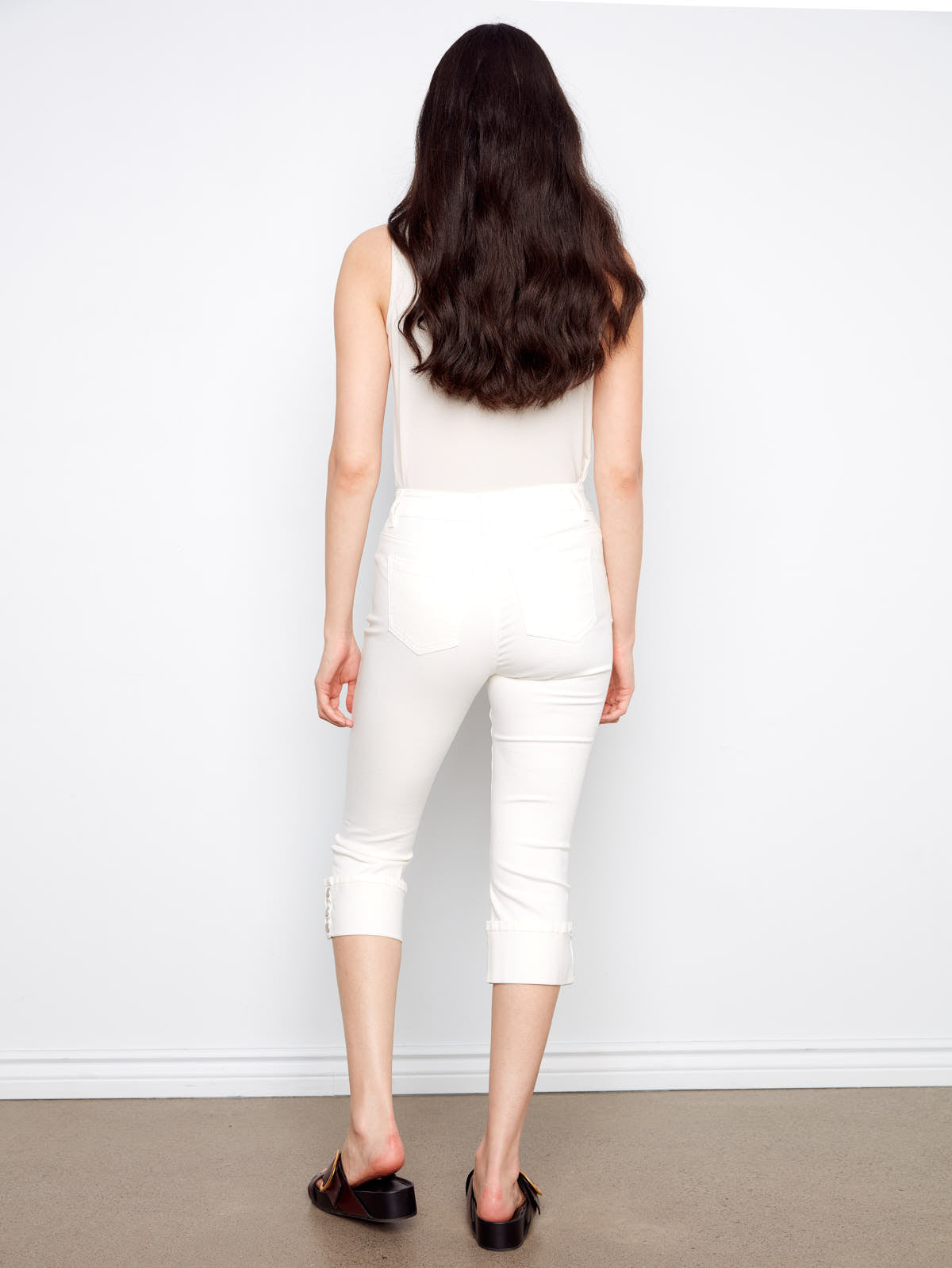 Back view of Charlie B Up Down 26” Cropped Capris in white, styled with black slip-on shoes by Charlie B.