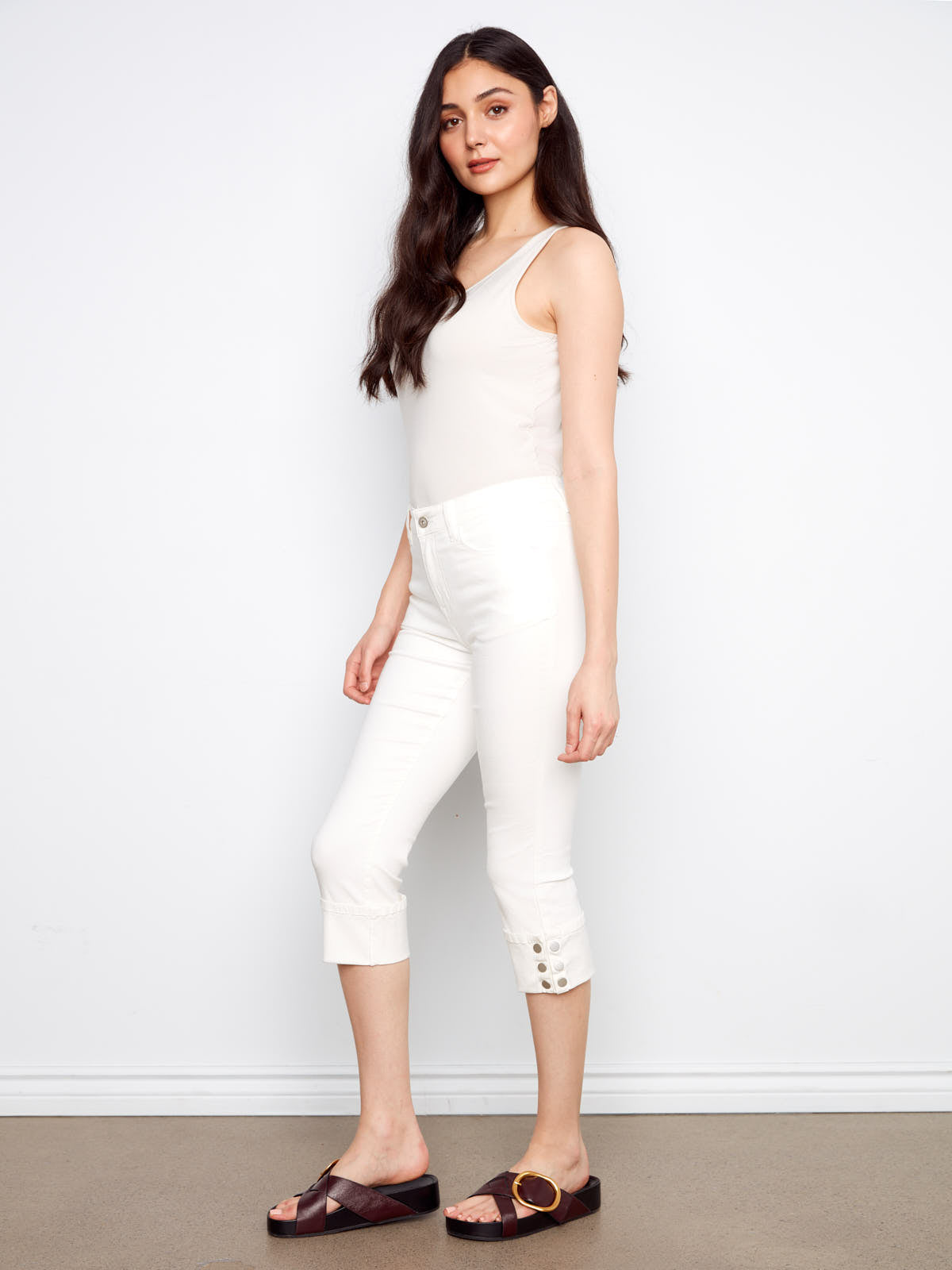 Slim fit white button detail Charlie B Up Down 26” Cropped Capris paired with a cream tank top and sandals