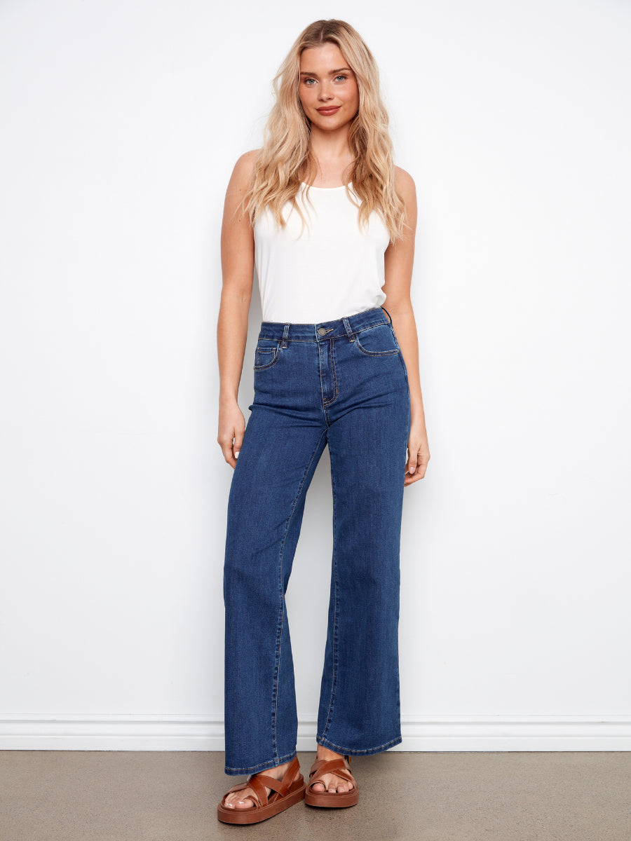 Light blue wide leg denim jeans by Charlie B styled with a white tank top and brown sandals, Charlie B Chloe Wide Leg Denim Jeans