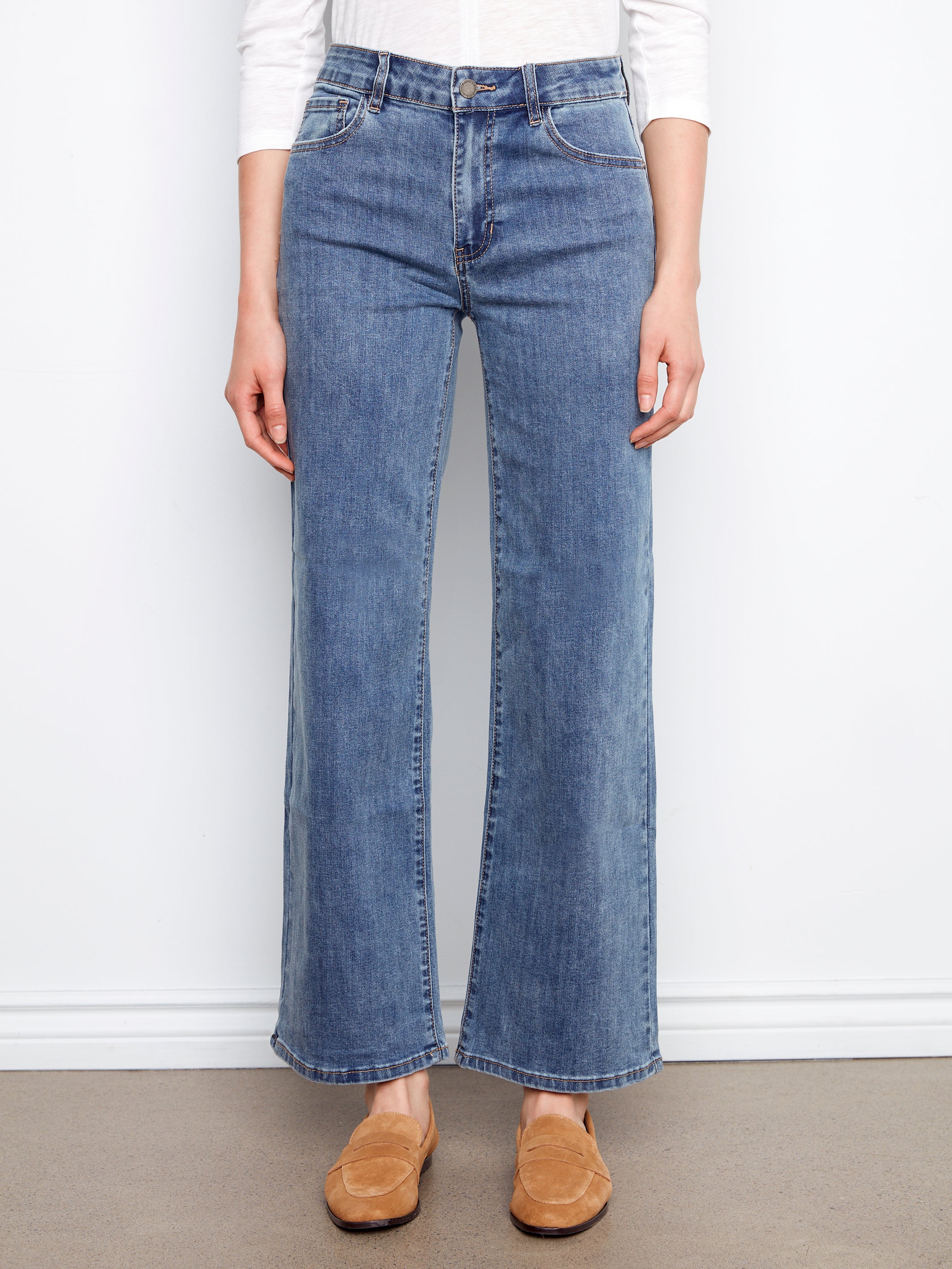 Charlie B Chloe Wide Leg Denim Jeans in medium blue styled with casual brown slip-on shoes by Charlie B